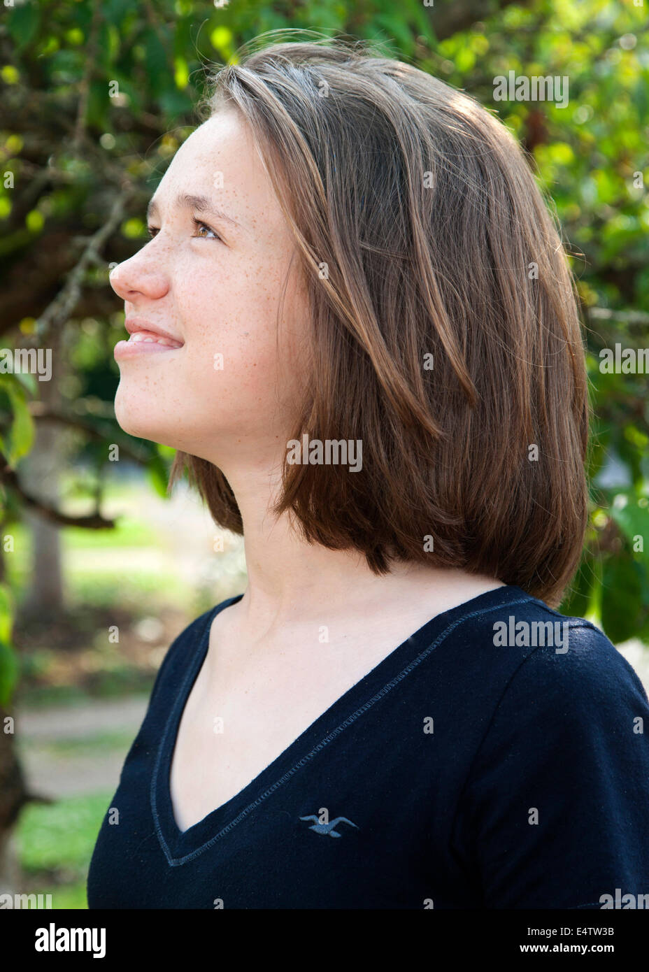 Young girl looking up at sky smiling Stock Photo - Alamy