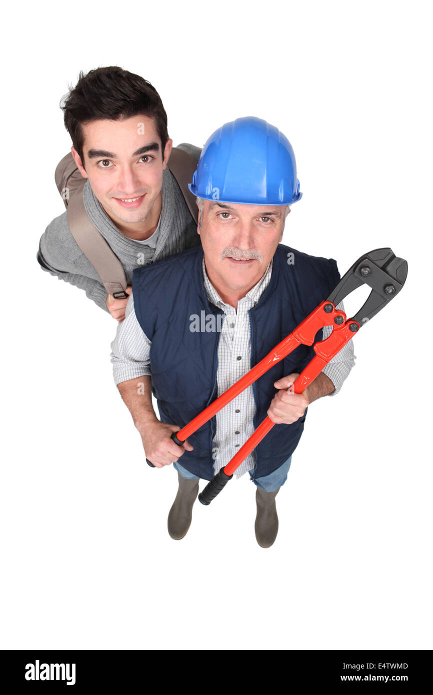 Eager young starter stood with manual worker Stock Photo