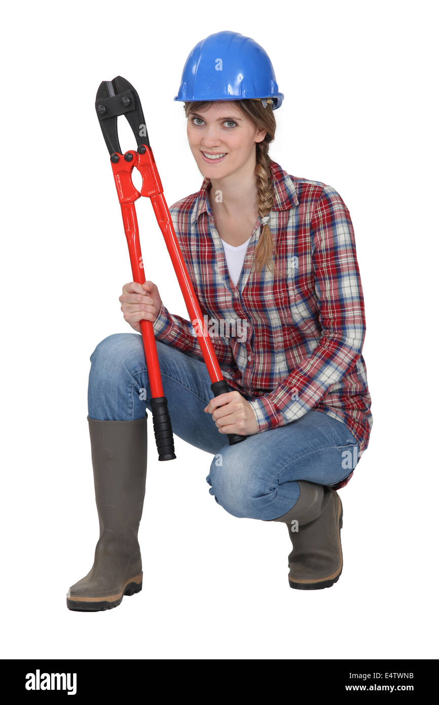 Woman crouching with bolt cutters Stock Photo