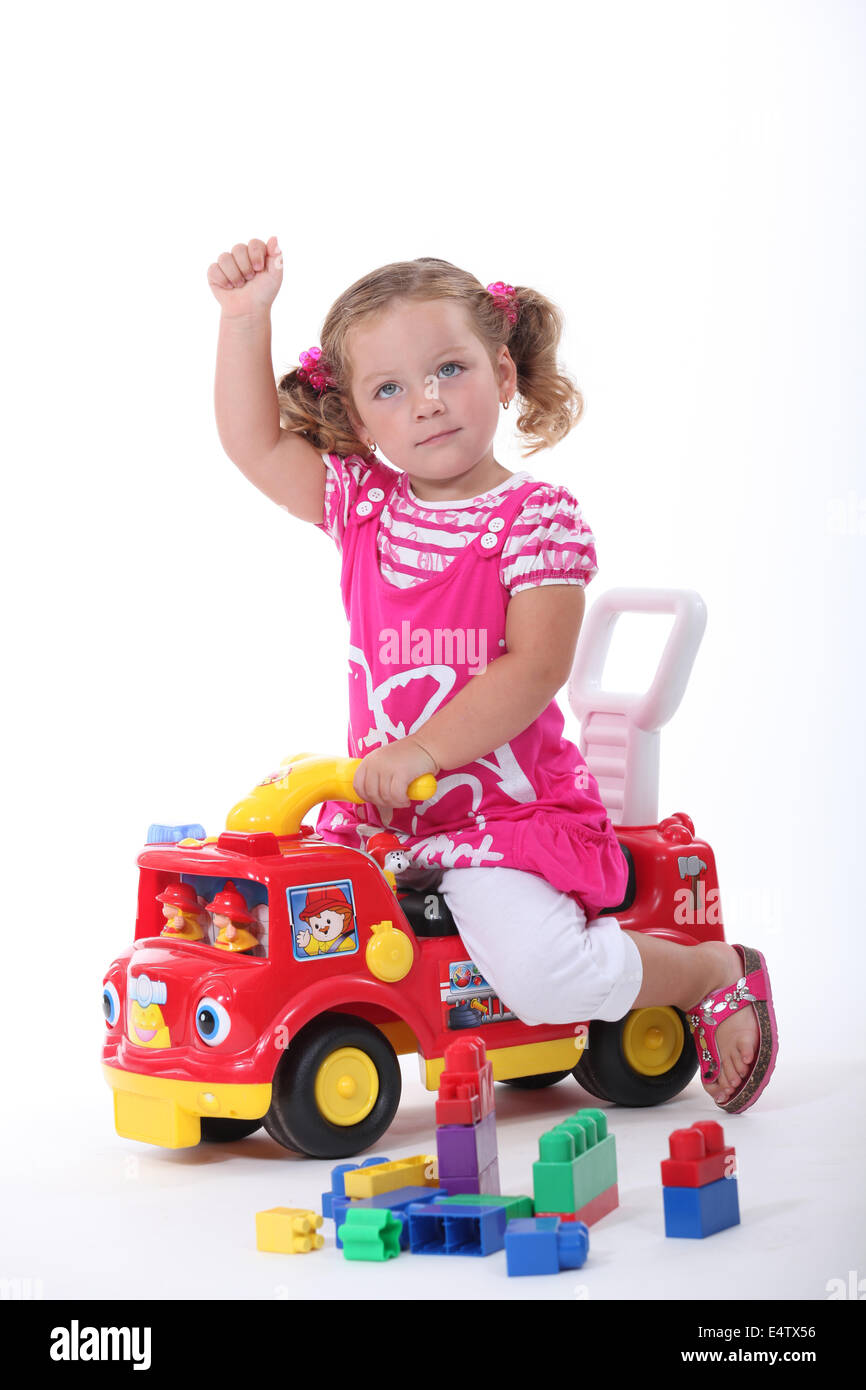 Girl on a toy car Stock Photo