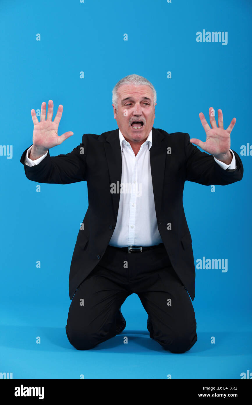 Handsome male in suit kneeling hi-res stock photography and images - Alamy