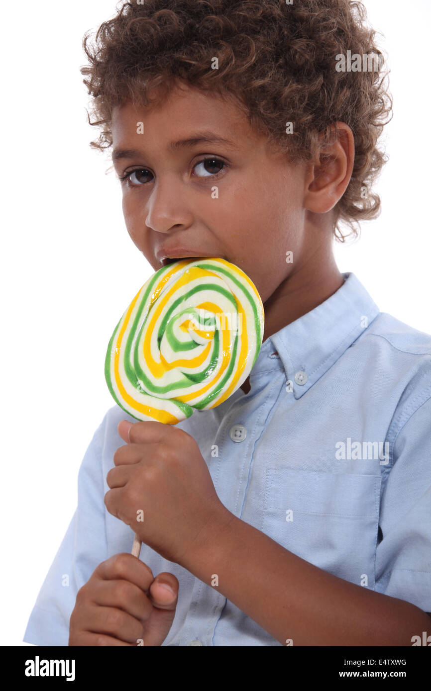 Boy licking a lollipop Stock Photo