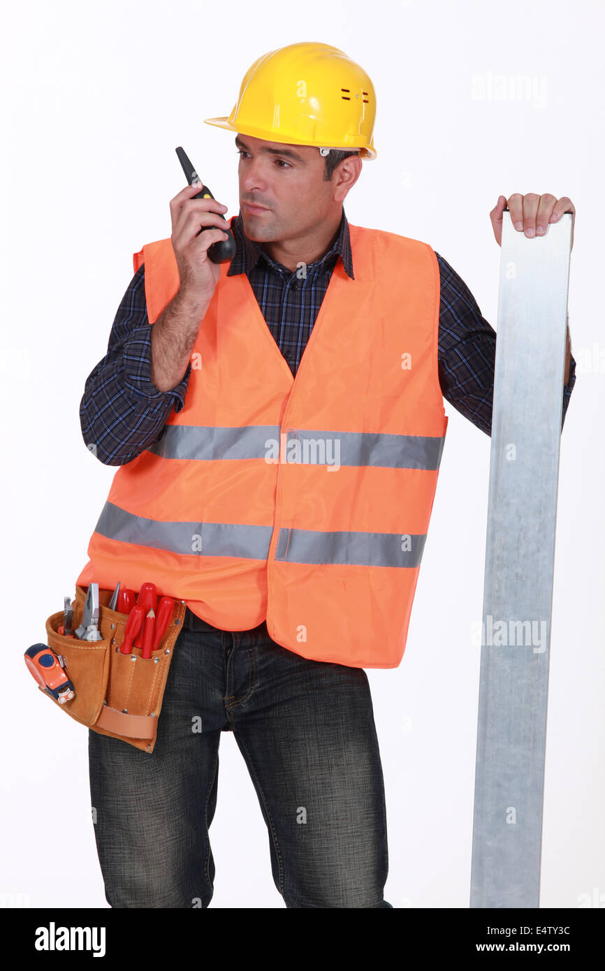 Tradesman speaking into a walkie talkie Stock Photo