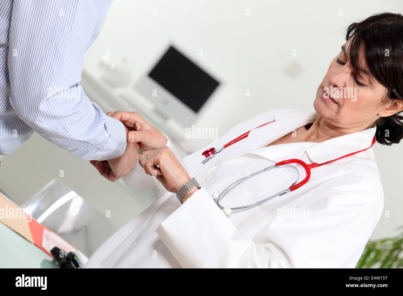 Doctor taking her patient's pulse Stock Photo