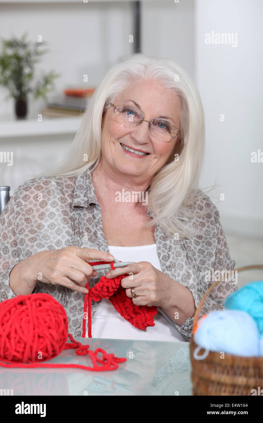 An old lady knitting. Stock Photo