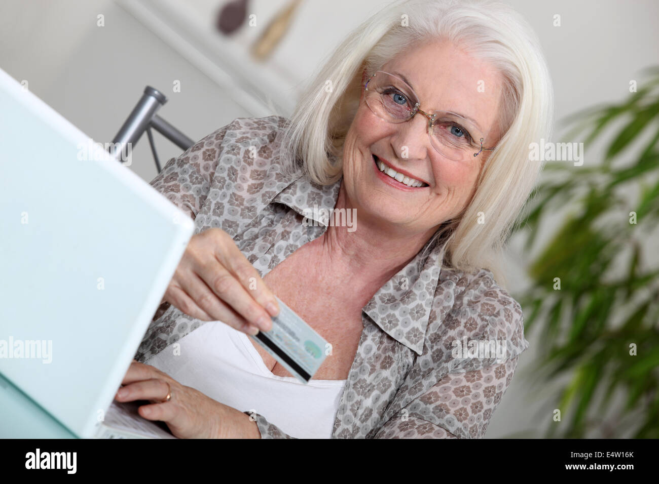 Elderly lady shopping on-line Stock Photo