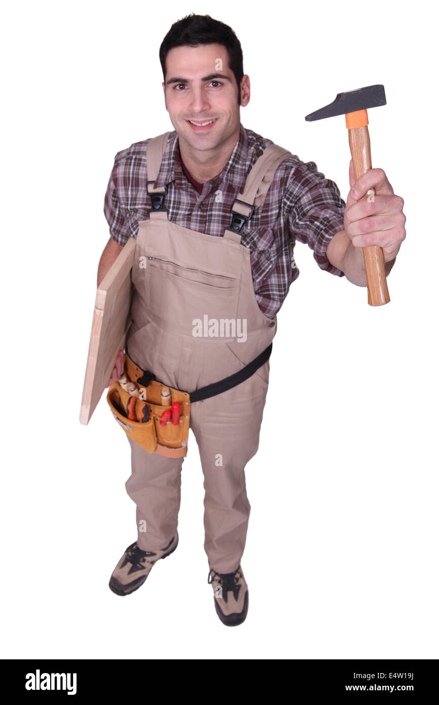 Tradesman holding up a tool Stock Photo