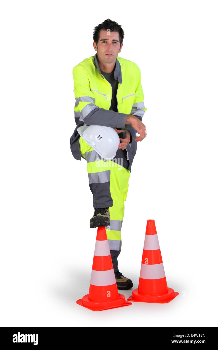 Traffic worker stood with cones Stock Photo