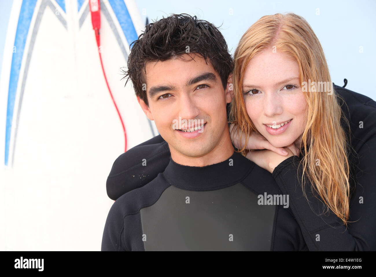 Two young surfers in wetsuits Stock Photo