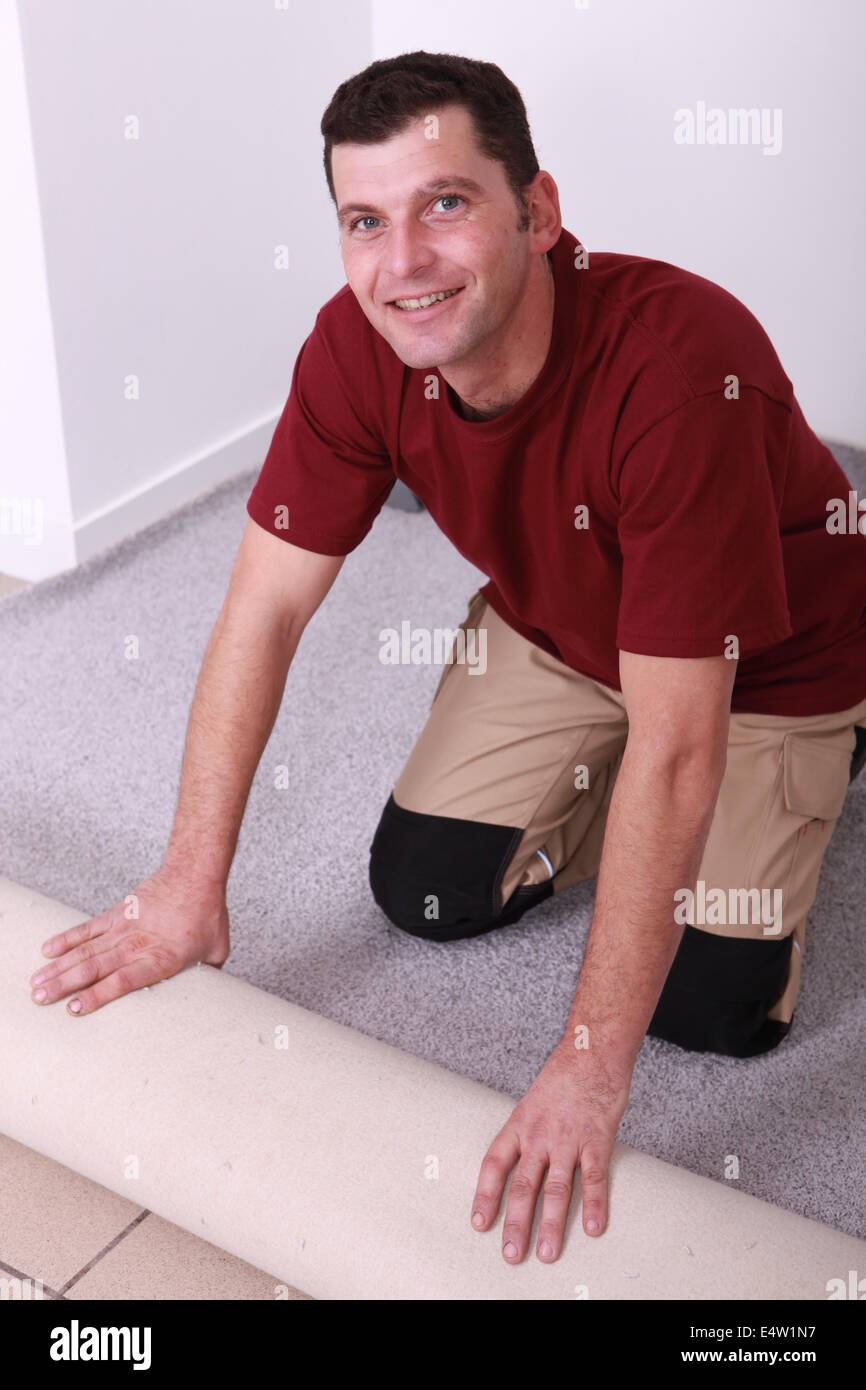 Horizontal image of a man laying carpet Stock Photo