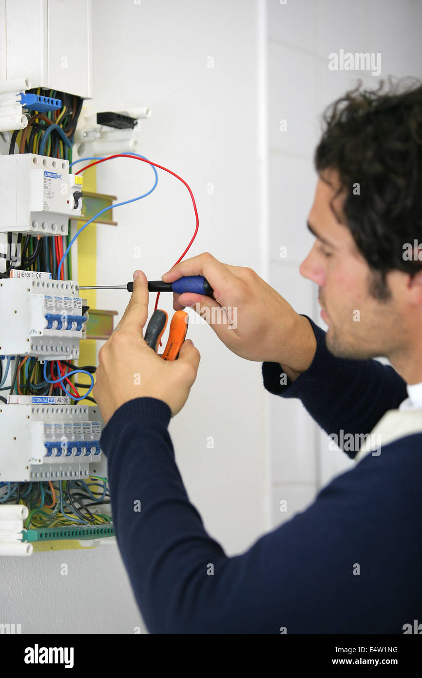 Man repairing faulty fuse box Stock Photo Alamy