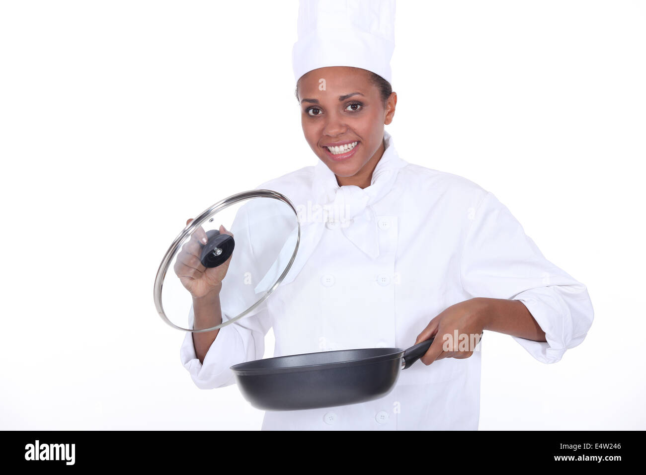 female chef exhibits a frying pan Stock Photo
