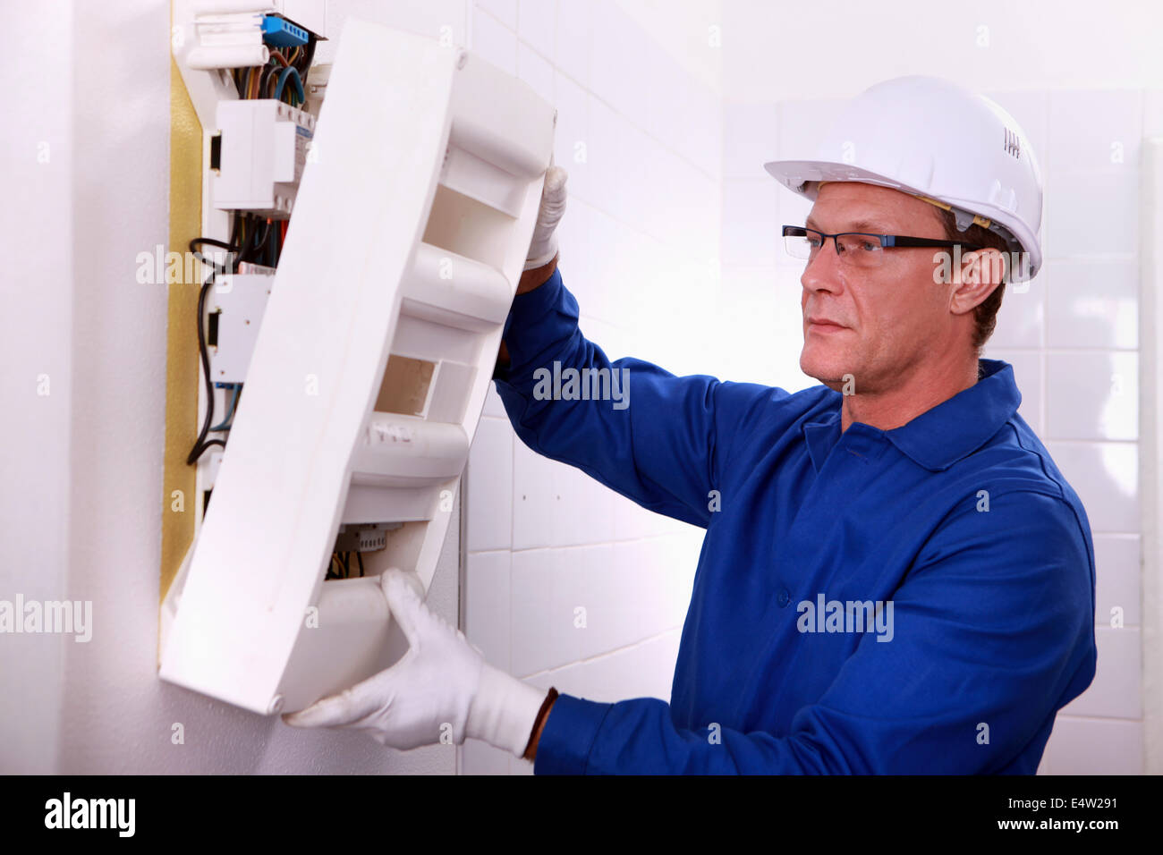 Electrician with a fusebox Stock Photo