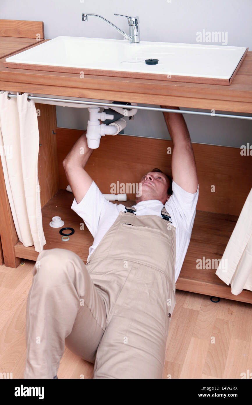 Plumber fixing sink Stock Photo Alamy