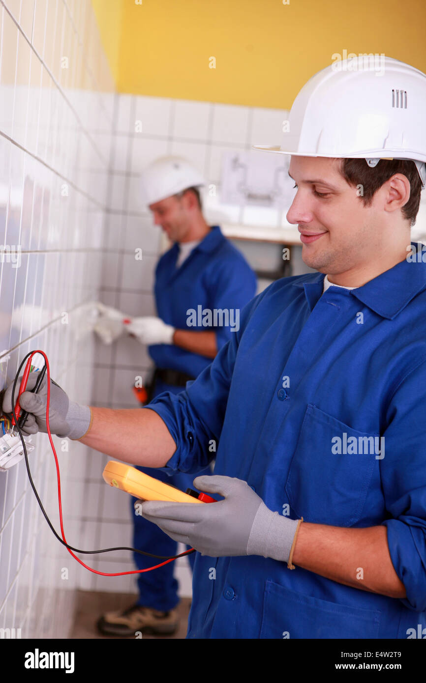 Two men inspecting power supply Stock Photo