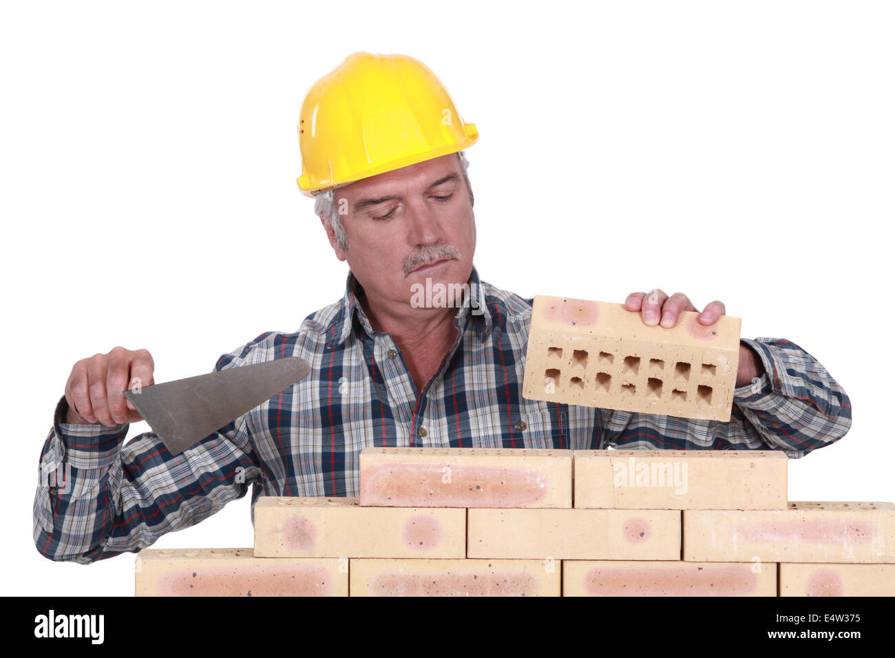Bricklayer laying bricks Stock Photo