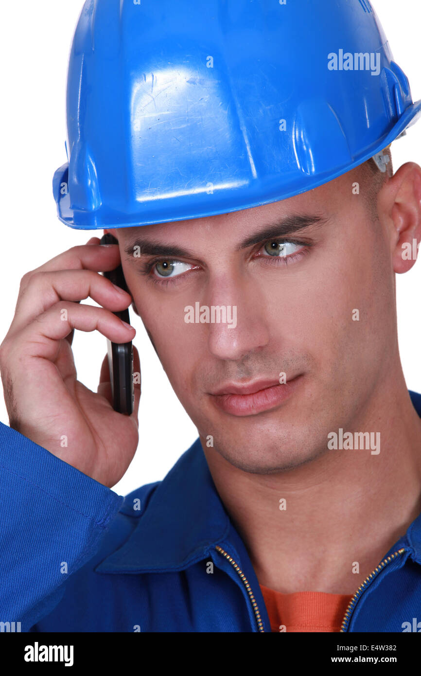 Tradesman talking on his mobile phone Stock Photo