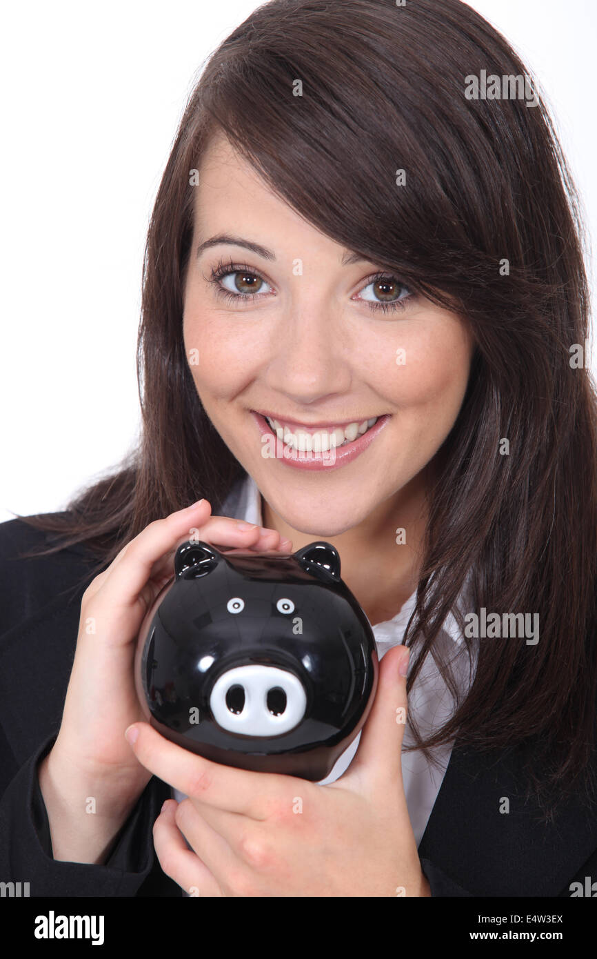 Brunette woman with piggy bank Stock Photo - Alamy