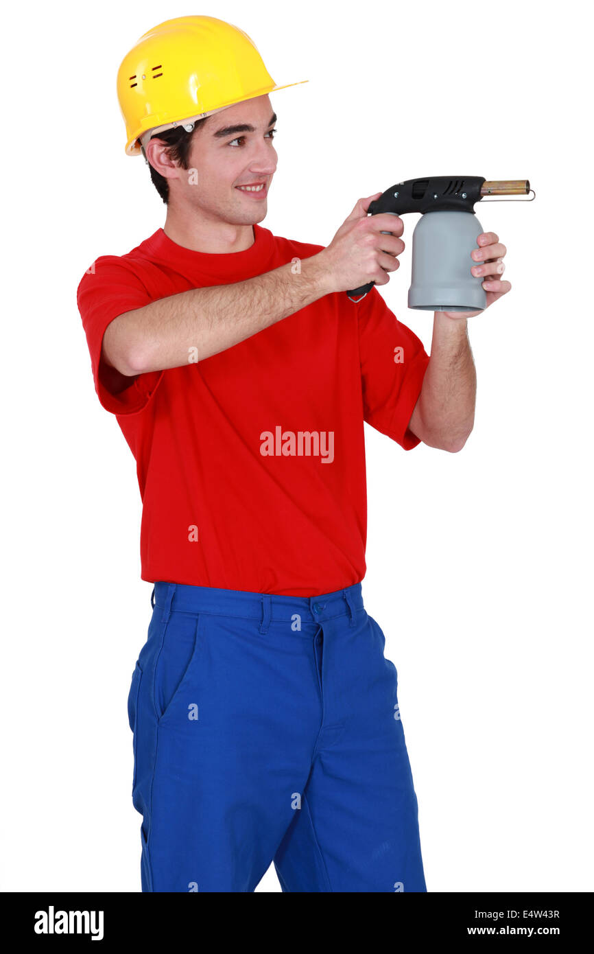 Tradesman holding a blowtorch Stock Photo