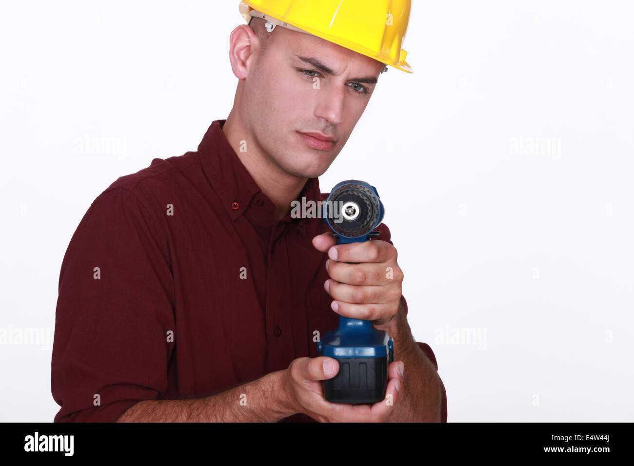 Tradesman aiming his power tool Stock Photo