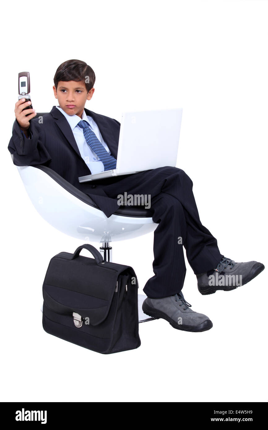 Young boy dressed as a surly businessman Stock Photo