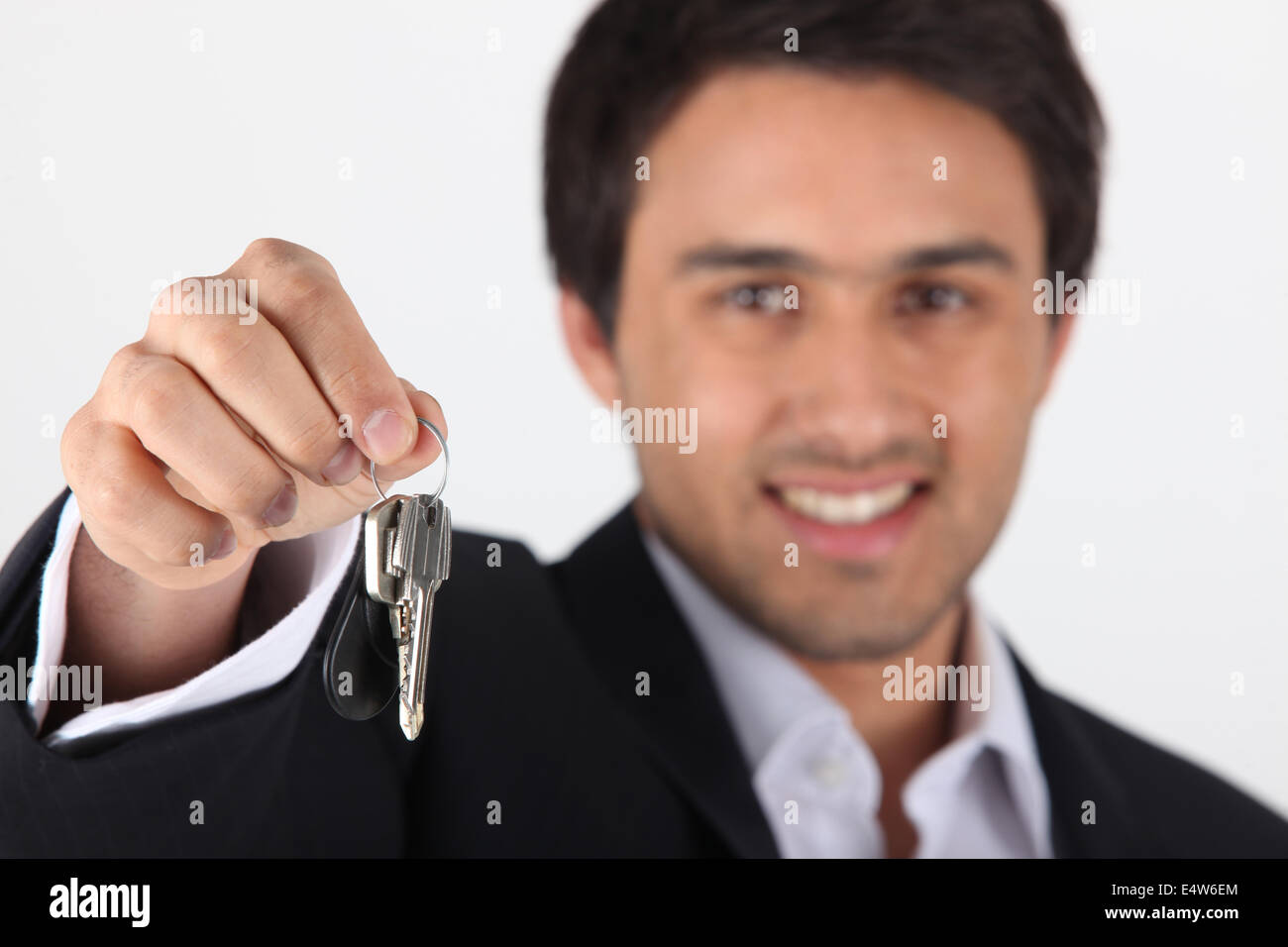 Businessman dangling keys Stock Photo