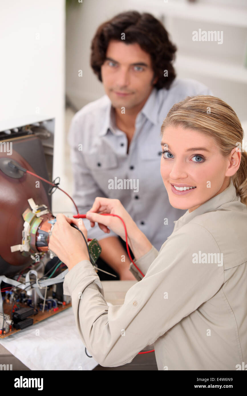 female technician repairing television Stock Photo Alamy