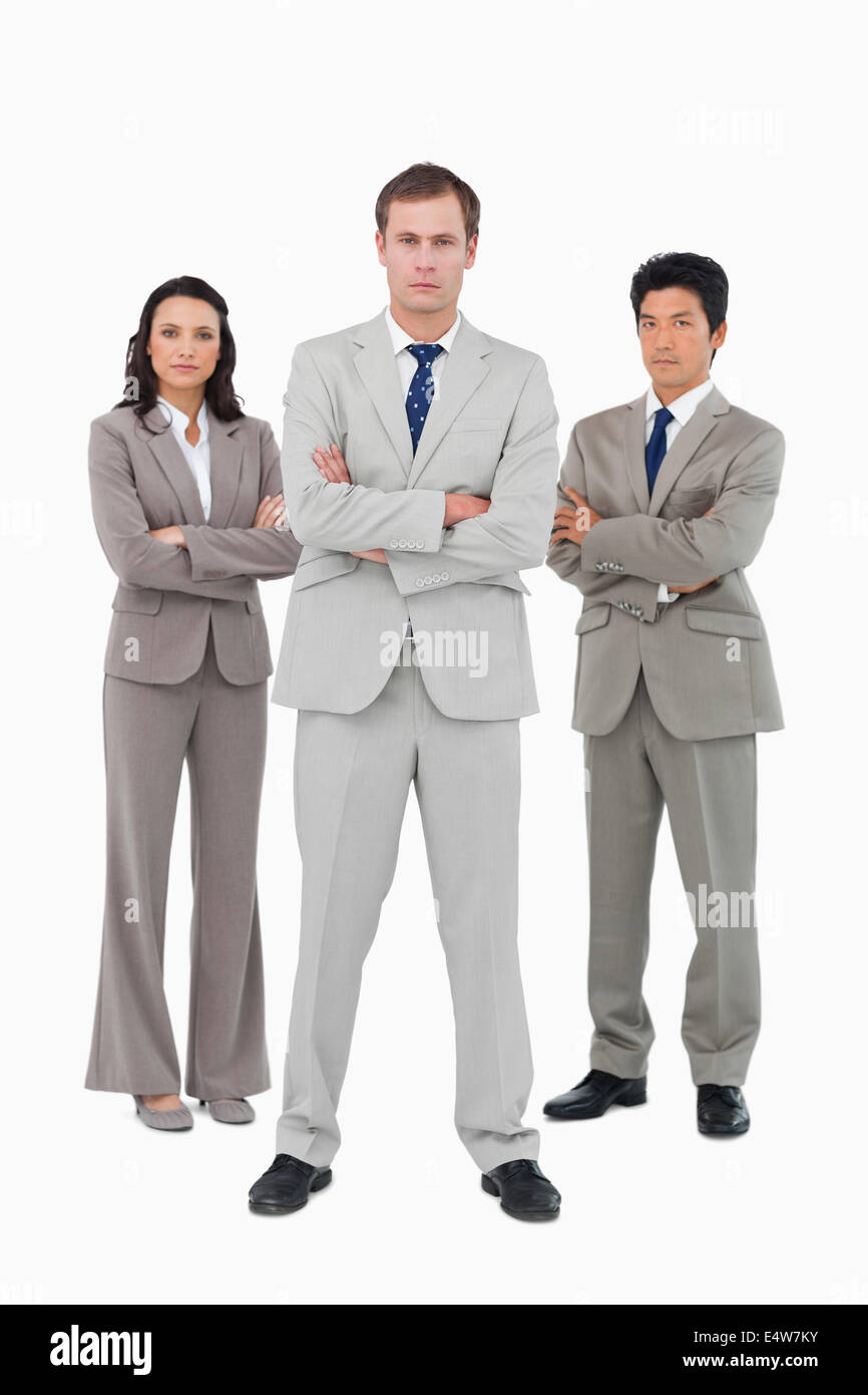 Serious young businessteam standing together Stock Photo - Alamy