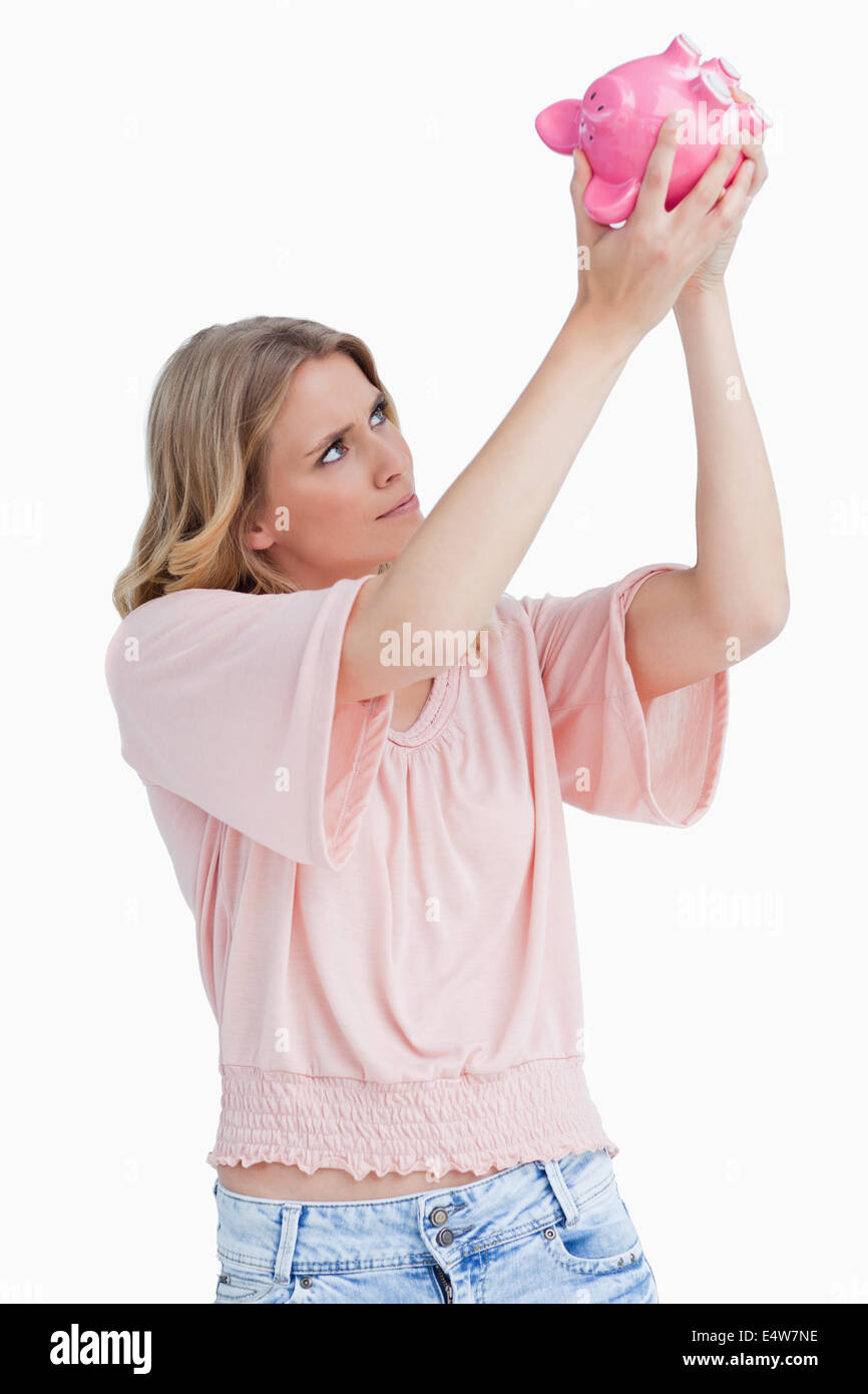 Woman looking inside of a piggy bank Stock Photo - Alamy