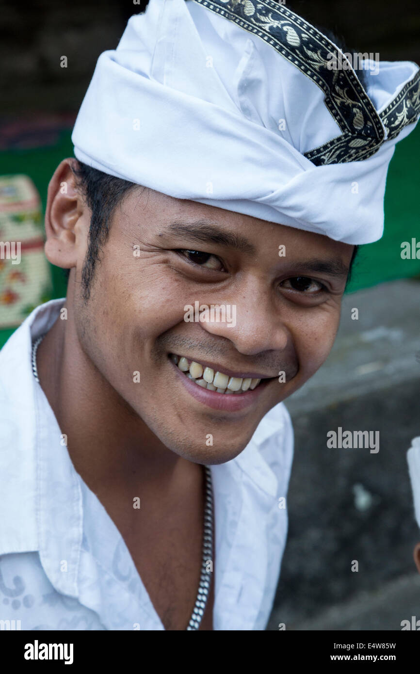 Bali, Indonesia. Young Hindu Man Wearing an Udeng, the Traditional Balinese Male Head Wrap.  Pura Dalem Temple, Dlod Blungbang. Stock Photo