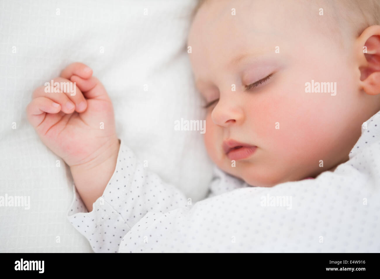 Peaceful baby lying on a bed while sleeping Stock Photo Alamy