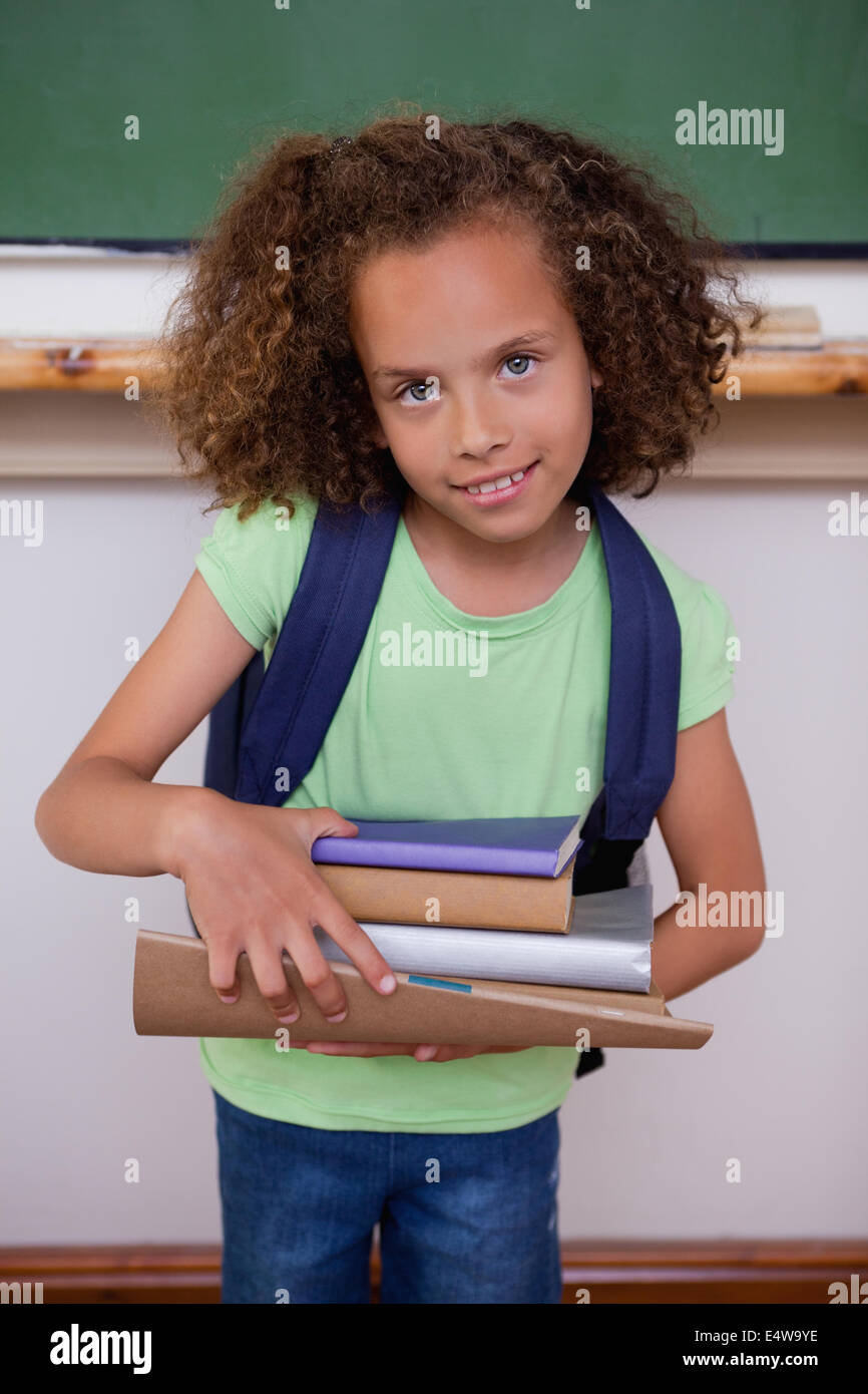 Portrait of a schoolgirl holding books Stock Photo - Alamy