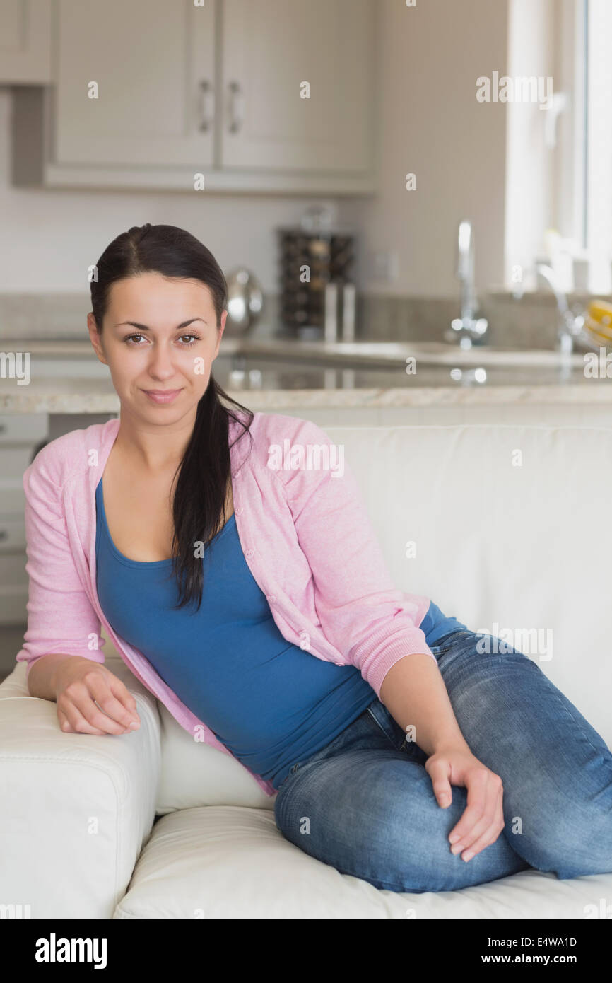Young woman relaxing on the couch Stock Photo - Alamy