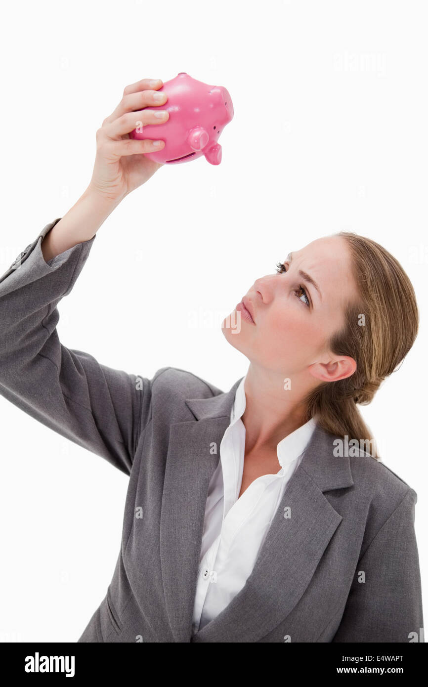 Bank employee looking at piggy bank Stock Photo - Alamy
