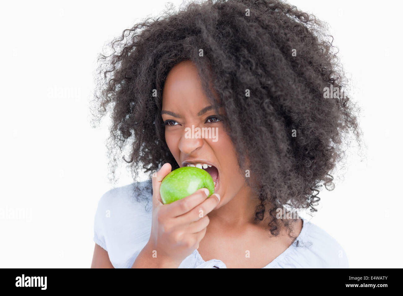 Young woman eating a green apple Stock Photo Alamy