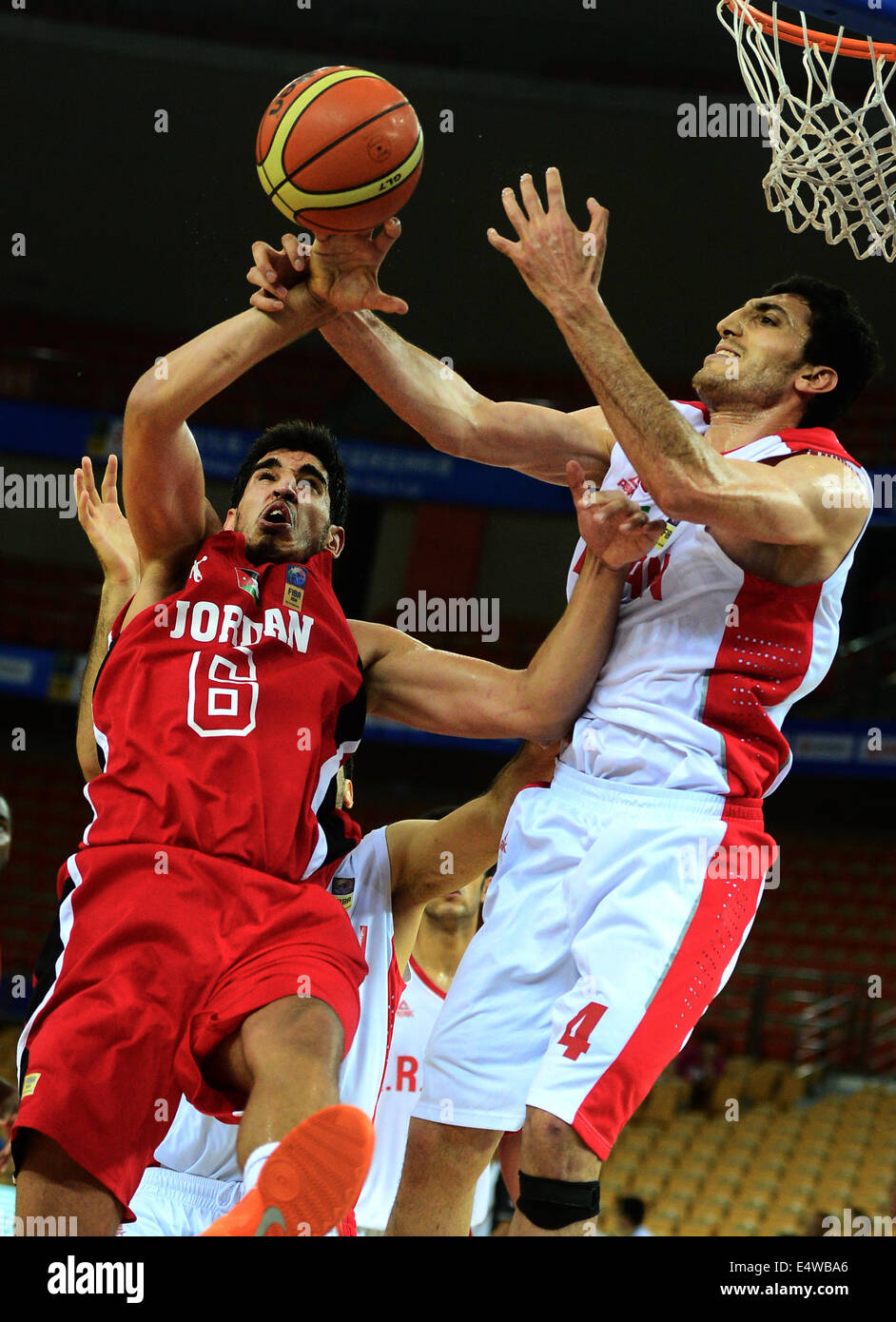 Wuhan, China's Hubei Province. 17th July, 2014. Al Dwairi Ahmad H. A. (L) of Jordan's men's basketball team competes during the quarterfinal match against Iran at the 5th FIBA Asia Cup in Wuhan, capital of central China's Hubei Province, July 17, 2014. Iran won 75-60 and advanced to the semifinal. © Cheng Min/Xinhua/Alamy Live News Stock Photo