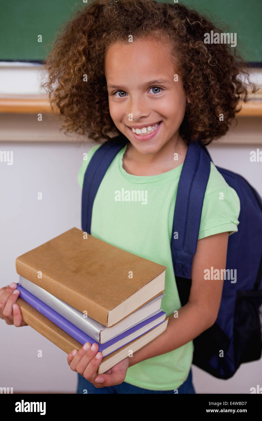 Portrait of a schoolgirl holding her books Stock Photo - Alamy