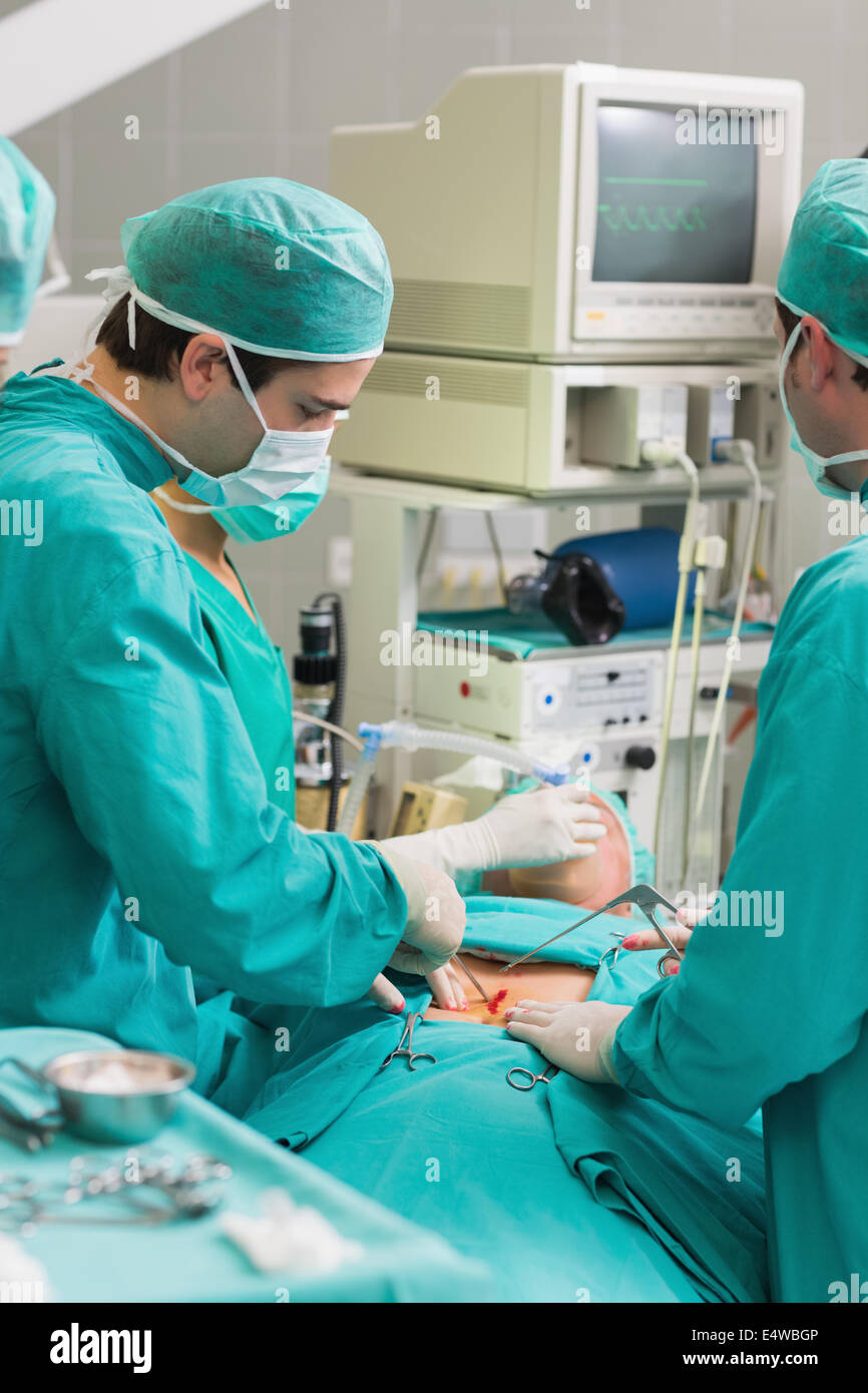 Surgeons using surgical tools Stock Photo Alamy