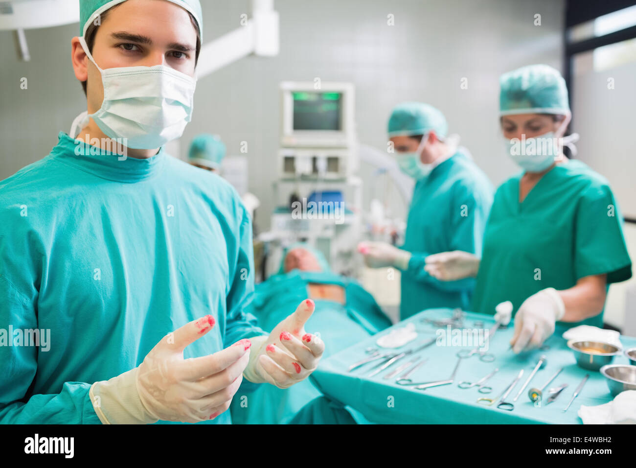 Работник после операции. Мужчина хирург в операционной.