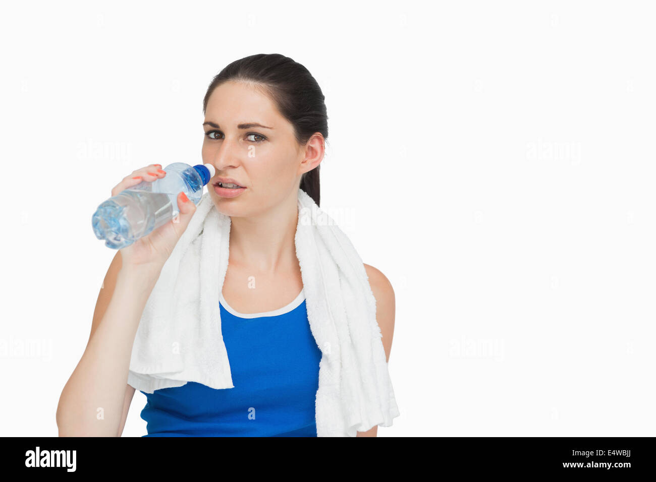 Sportswoman with a towel drinking water Stock Photo - Alamy