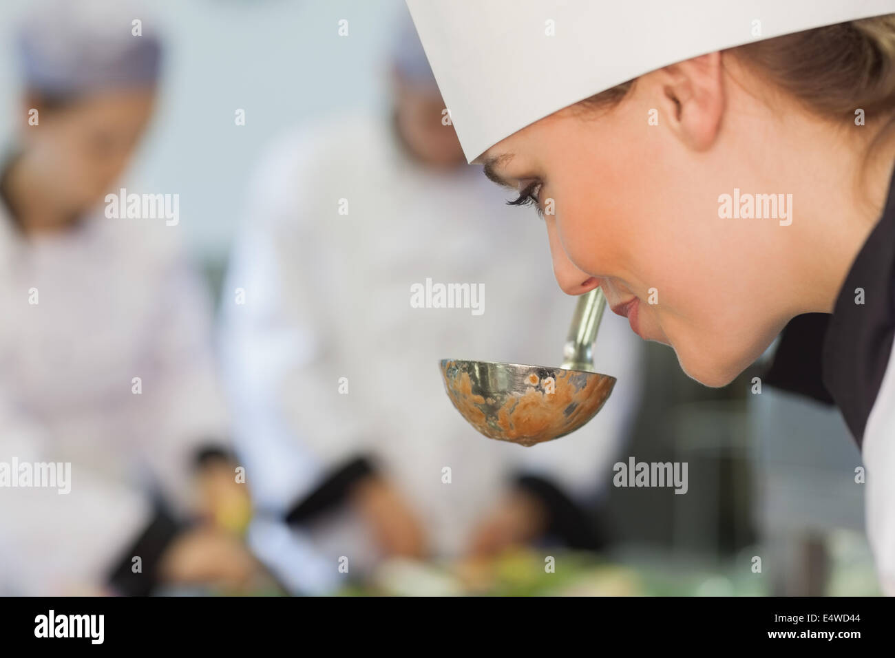 Smiling chef smelling the soup Stock Photo