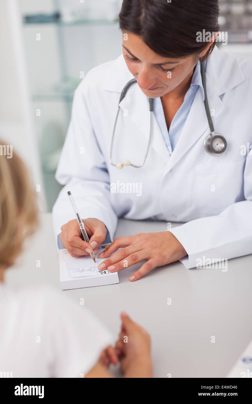 Doctor writing on a prescription note Stock Photo - Alamy