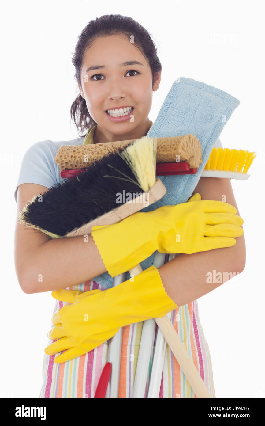 Woman nearly dropping her cleaning tools Stock Photo