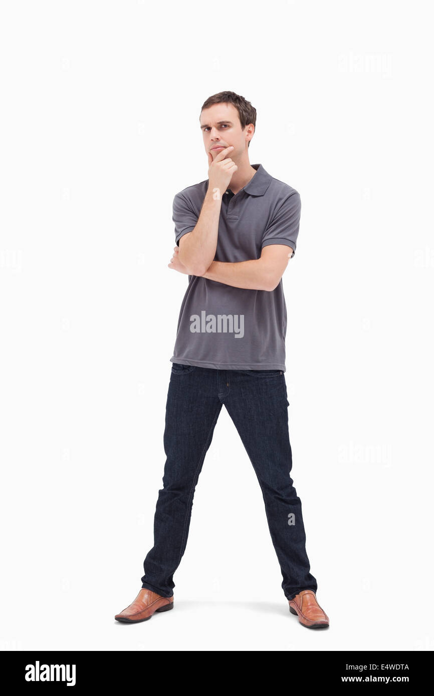 Thoughtful standing man with his legs apart Stock Photo Alamy