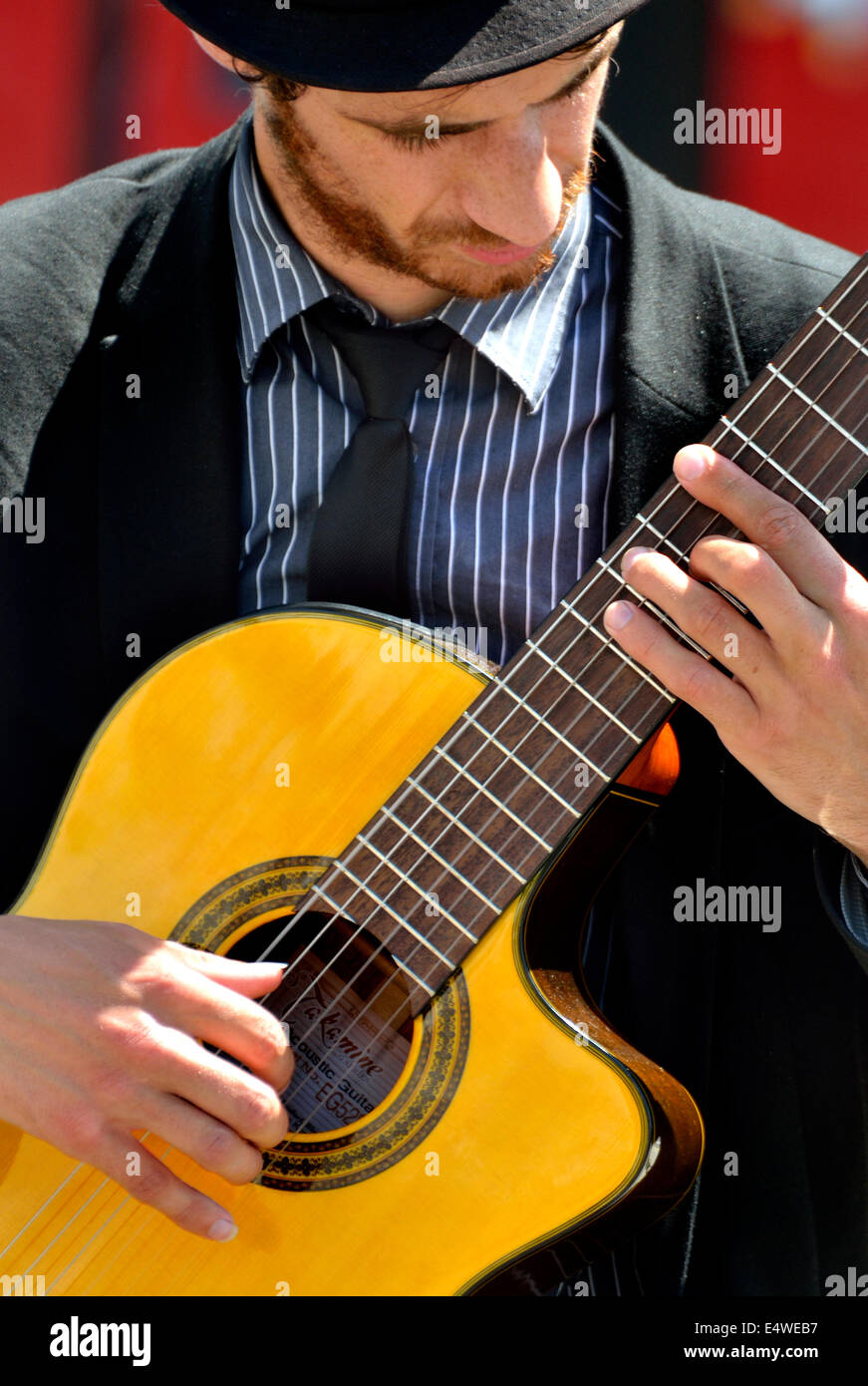 London, England, UK. Guitarist busking in Trafalgar Square Stock Photo