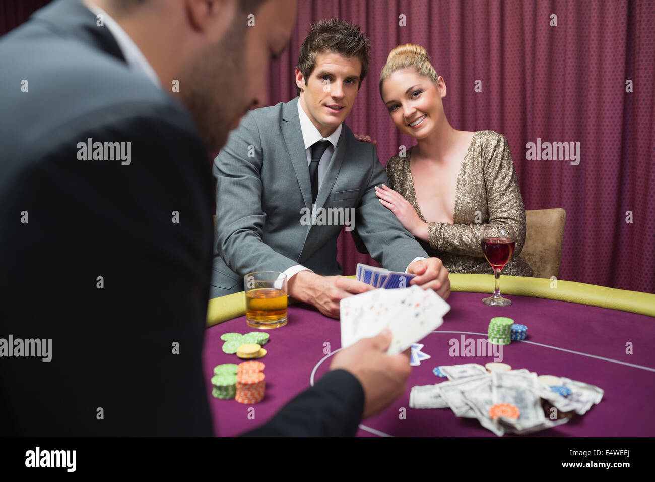 Couple playing poker and smiling Stock Photo