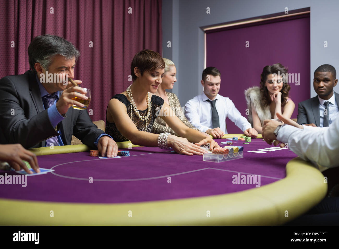 People sitting playing poker Stock Photo