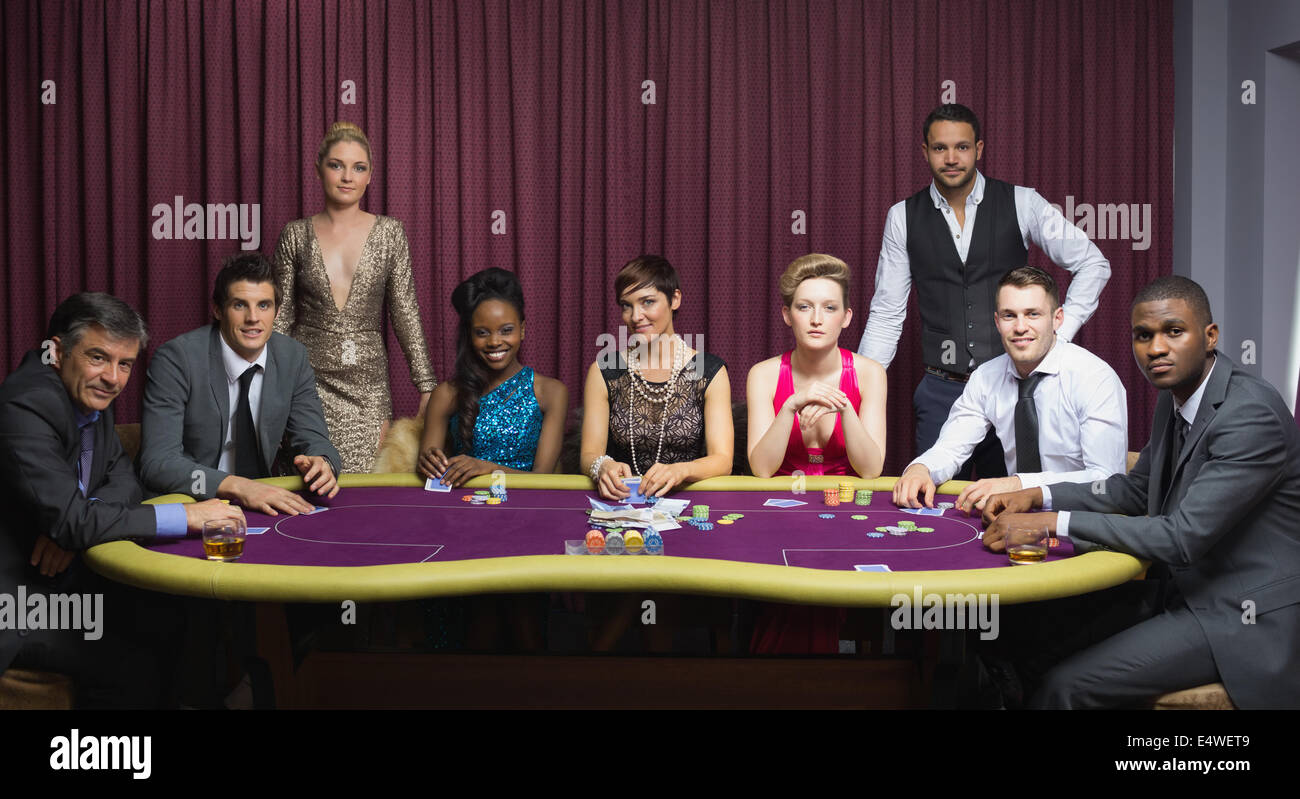 Well-dressed group at poker table Stock Photo