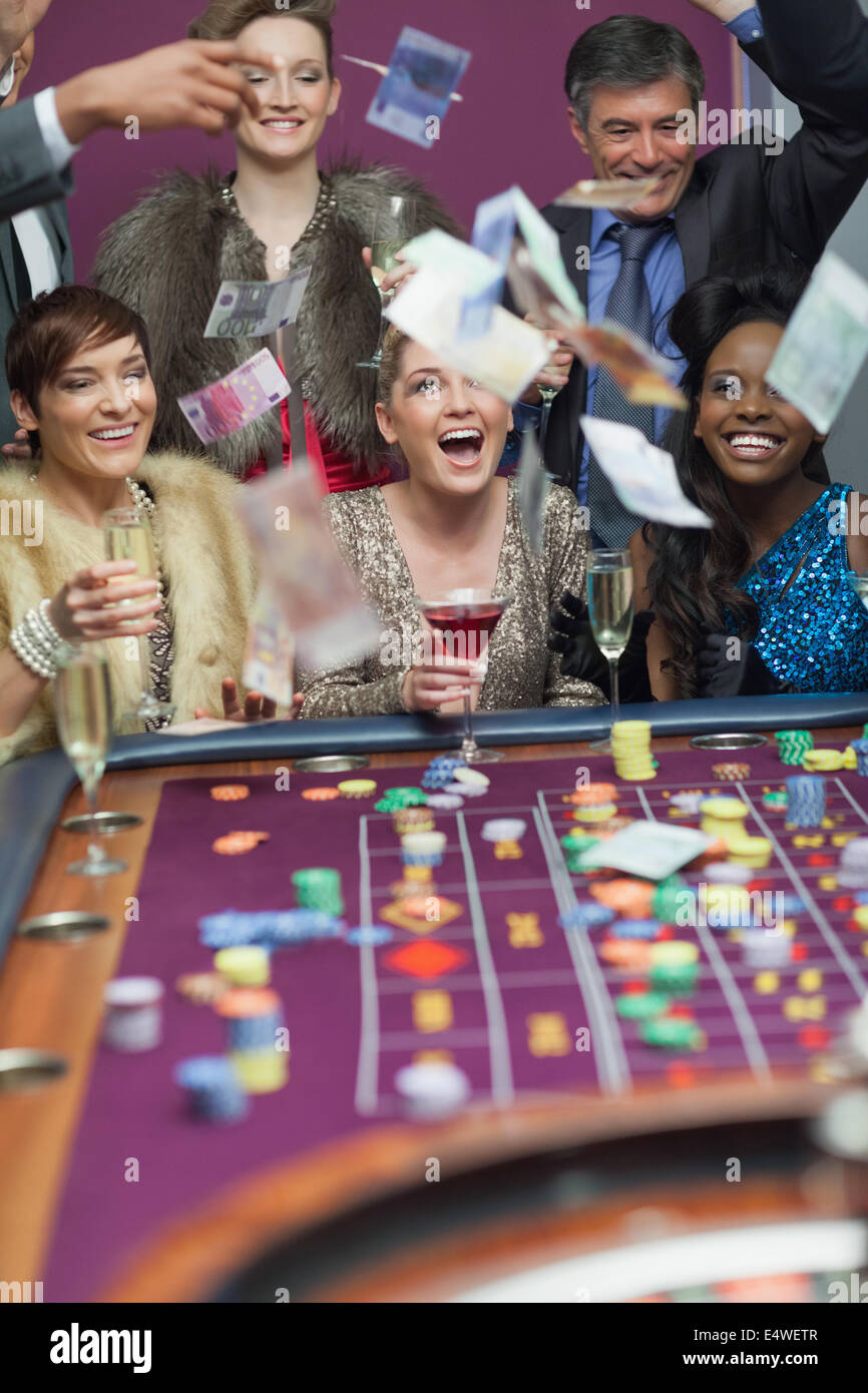 People throwing money while smiling Stock Photo Alamy