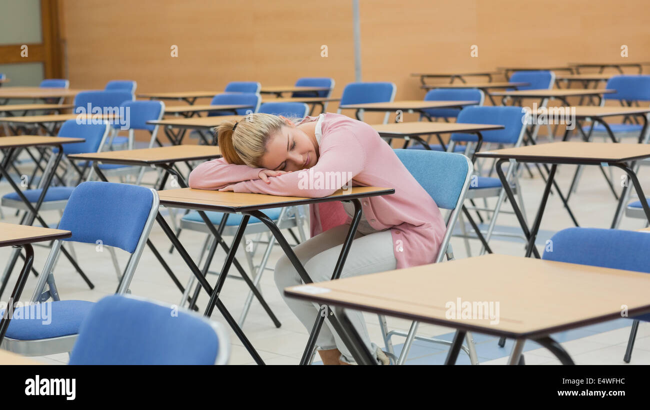 Woman napping in exam hall Stock Photo